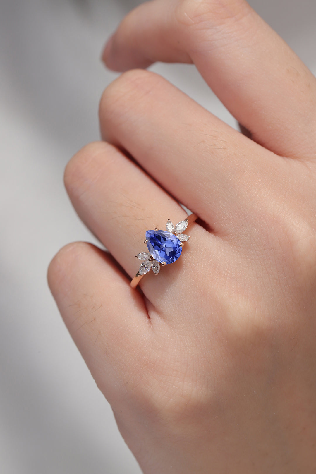 Nature Inspired Pear Cut Cornflower Sapphire with Petal Side Engagement Ring