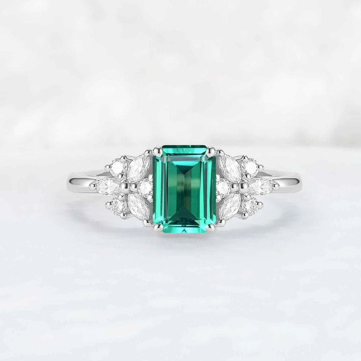 Nature Inspired Emerald Cut Emerald Ring with Petal Moissanite Side Stones