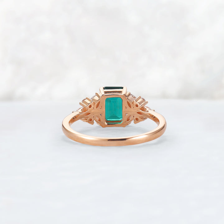 Nature Inspired Emerald Cut Emerald Ring with Petal Moissanite Side Stones